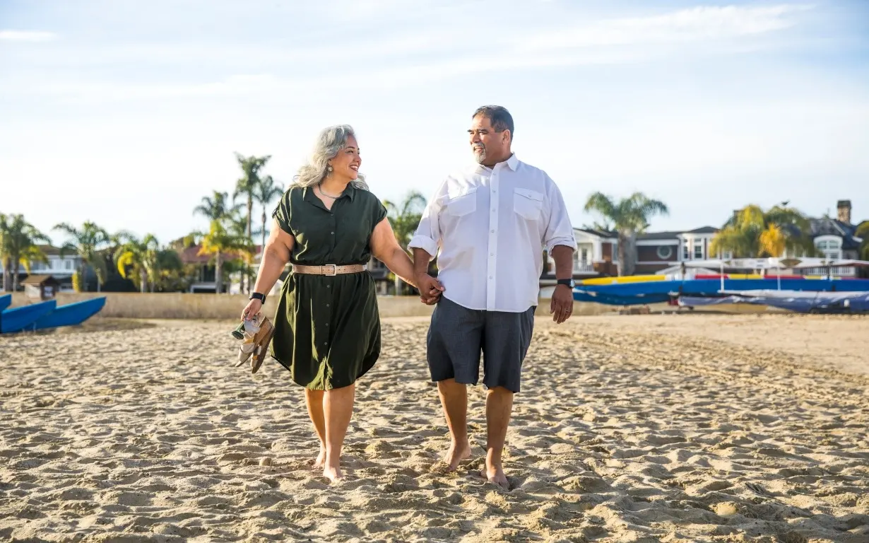 Photo of a man and woman walking on the beach